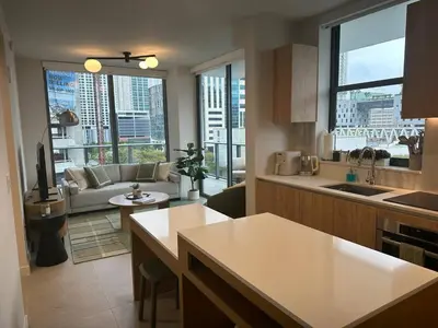 a kitchen and living room with a view of a city at Sophisticated 2BR2BA at Miami World Center in Miami
