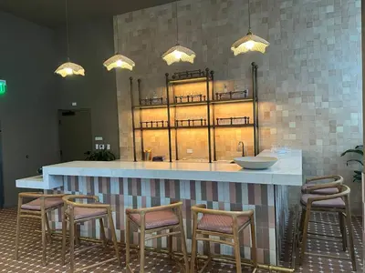 a bar with chairs and a counter with lights at Sophisticated 2BR2BA at Miami World Center in Miami