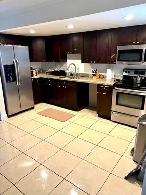 a kitchen with wooden cabinets and stainless steel appliances at Exclusive suites in Fort Lauderdale