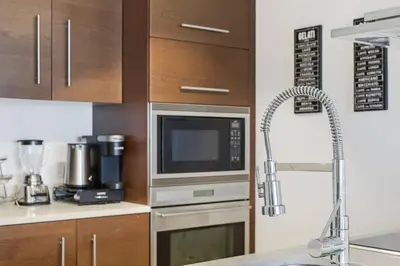 a kitchen with a microwave oven and a sink at Luxury Brickell Condo with Skyline & Bay Views in Miami