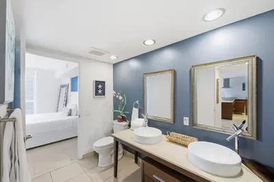 a bathroom with two sinks and a toilet at Luxury Brickell Condo with Skyline & Bay Views in Miami
