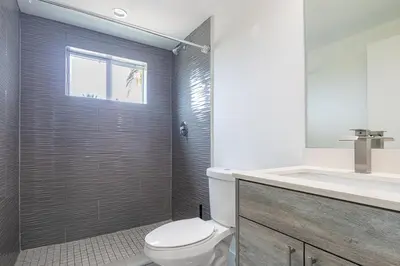 a bathroom with a toilet and a shower and a sink at Stylish 3BR Apartment, 4 Beds, Great for Groups with Free Parking in Hallandale Beach