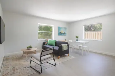 a living room with a couch and a table at Comfy 2BR Apartment Near Las Olas with Patio, BBQ and FREE PARKING in Fort Lauderdale