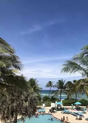 a view of a resort with a pool and palm trees at Hollywood Beach, Miami, Oceanfront retreat in Hollywood