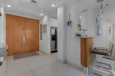 a kitchen with a wooden door and a hallway at Luxury Brickell 3BD Free Parking - Pool - Bay View in Miami