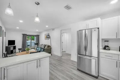 a kitchen with white cabinets and a stainless steel refrigerator at West Brickell #2 Renovated 2 2 Apt + Parking in Miami