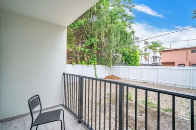 a balcony with a chair and a fence at West Brickell #2 Renovated 2 2 Apt + Parking in Miami