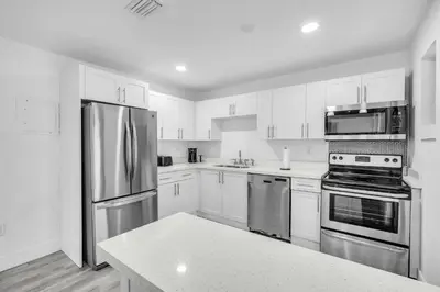 a kitchen with white cabinets and stainless steel appliances at West Brickell #2 Renovated 2 2 Apt + Parking in Miami