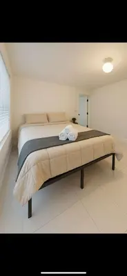 a bedroom with a large bed in a room at Santorini Wynwood in Miami