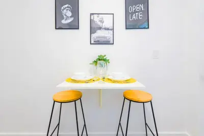 a table with two stools and a plate on it at Relaxing Studio with Modern Comfort in Miami