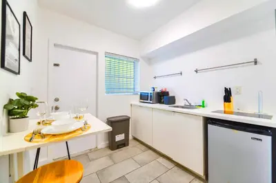 a kitchen with a counter and a table and a sink at Relaxing Studio with Modern Comfort in Miami