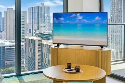 a flat screen tv sitting on a stand in front of a window at Downtown Drift-Luxury Amenities Sauna & Pool in Miami
