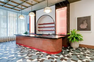 a lobby with a brick counter with a mirror at Downtown Drift-Luxury Amenities Sauna & Pool in Miami