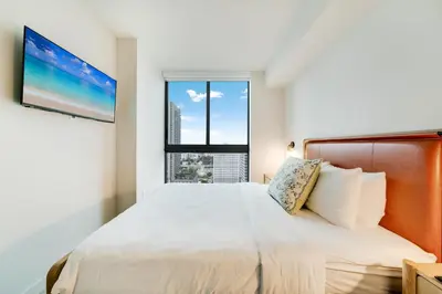 a bedroom with a large bed with a large window at Downtown Drift-Luxury Amenities Sauna & Pool in Miami