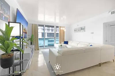 a white living room with a large white couch at Luxury by the Sea- 2BR Pool & Gym -Hollywood in Hollywood