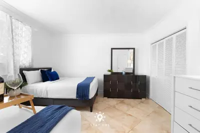 a bedroom with a bed and a dresser and a mirror at Luxury by the Sea- 2BR Pool & Gym -Hollywood in Hollywood