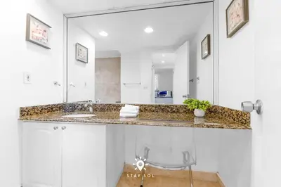 a bathroom with a sink and a mirror at Luxury by the Sea- 2BR Pool & Gym -Hollywood in Hollywood