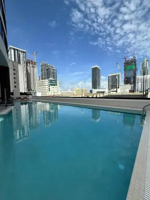 a large pool of blue water in front of a city at Downtown Miami 1BR Walk to Bayside Kaseya Gym Pool in Miami