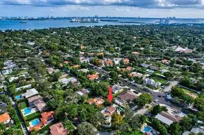 an aerial view of a residential suburb with a red arrow at Villa 800 - 3 BEDROOM - 3 AND A HALF BATHROOMS -6 BEDS- Spa like Retreat Saline Pool & Jacuzzi in Miami
