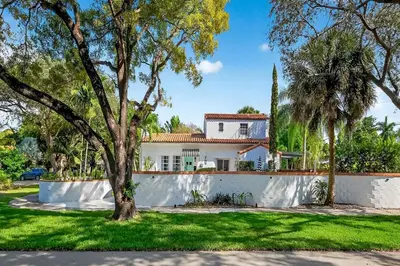a house with a white fence and trees at Villa 800 - 3 BEDROOM - 3 AND A HALF BATHROOMS -6 BEDS- Spa like Retreat Saline Pool & Jacuzzi in Miami