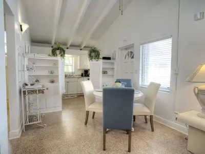 a dining room with a table and chairs and a kitchen at Holiday Home Guest House at the Ocean by Interhome in Fort Lauderdale