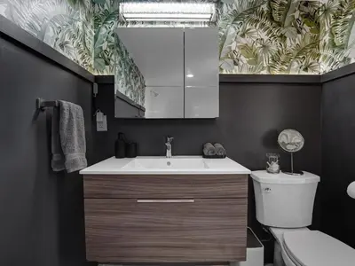 a bathroom with a sink and a toilet and a mirror at Holiday Home 2BR - 2 bath Beheizter Pool- Familien-Haustierfreundlicher Spaß by Interhome in Fort Lauderdale