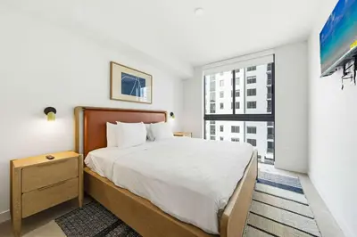 a bedroom with a bed and a large window at Miami Highline- Sauna Heated Pool Cabanas in Miami