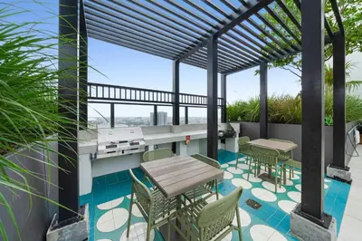 a patio with a table and chairs on a balcony at Miami Highline- Sauna Heated Pool Cabanas in Miami