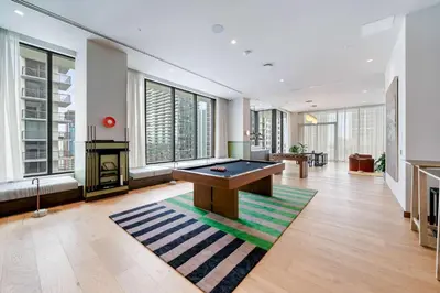 a pool table in a room with windows at Miami Highline- Sauna Heated Pool Cabanas in Miami
