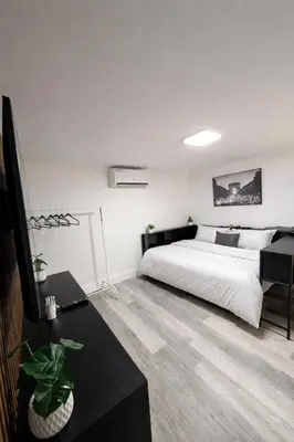 a bedroom with a bed and a black table at PrimeStay Modern Studio in Prime Location in Hollywood