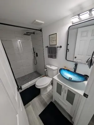 a bathroom with a toilet and a blue sink at PrimeStay Modern Studio in Prime Location in Hollywood