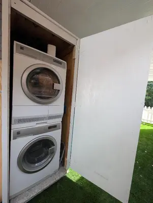 a washer and dryer inside of a house at PrimeStay Modern Studio in Prime Location in Hollywood