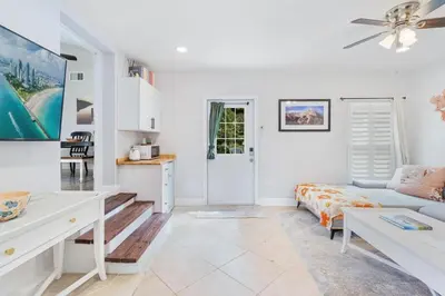 a living room with a couch and a table at Shady Banks Oasis in Fort Lauderdale