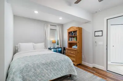 a bedroom with a bed and a book shelf at Shady Banks Oasis in Fort Lauderdale
