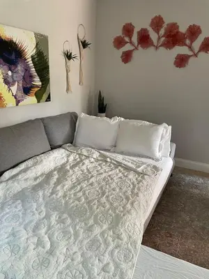 a bedroom with a bed and two paintings on the wall at Shady Banks Oasis in Fort Lauderdale