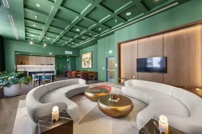 a living room with couches and a television and a piano at Downtown Stay with Rooftop Pool Amenities in Miami