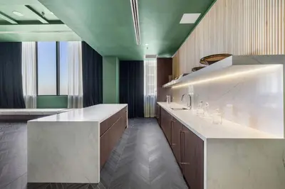 a large kitchen with a white counter and green ceilings at Downtown Stay with Rooftop Pool Amenities in Miami