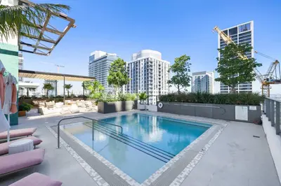 a swimming pool on top of a building with buildings at Downtown Stay with Rooftop Pool Amenities in Miami