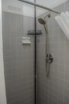 a shower with a shower head in a bathroom at Central location in Cutler Bay