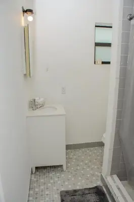 a white bathroom with a sink and a tub at Central location in Cutler Bay