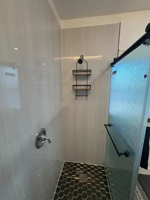 a bathroom with a shower with a glass door at Villa Habana in Miami