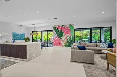 a large living room with a kitchen and a living room at Casa Monstera Heated Saltwater Pool Game Room Golf in Fort Lauderdale