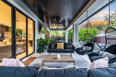 a living room with a couch and a table at Casa Monstera Heated Saltwater Pool Game Room Golf in Fort Lauderdale