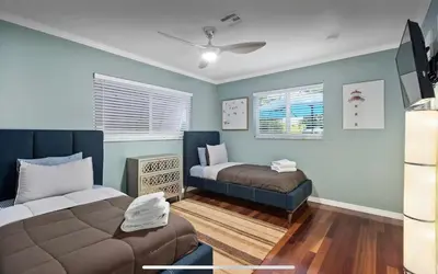 a room with a bed and a couch in it at Private Oasis with Heated Saltwater Pool Tropical Backyard in Dania Beach