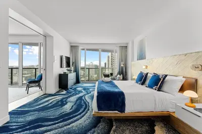 a bedroom with a large bed with a blue carpet at W Fort Lauderdale Corner Unit with Ocean View and Resort Access - 2BR 2BA in Fort Lauderdale