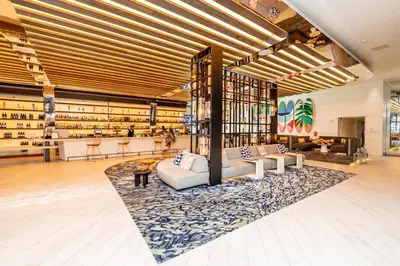 a large room with couches and a rug at W Fort Lauderdale Corner Unit with Ocean View and Resort Access - 2BR 2BA in Fort Lauderdale