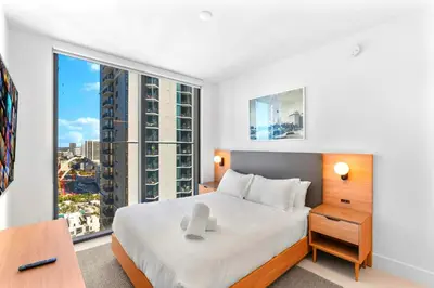 a bedroom with a bed and a large window at Luxury Bayfront Condo - Downtown Location in Miami