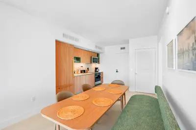 a dining room with a wooden table and chairs at Luxury Bayfront Condo - Downtown Location in Miami