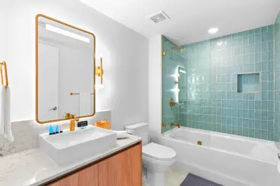 a bathroom with a tub and a sink and a toilet at Luxury Bayfront Condo - Downtown Location in Miami