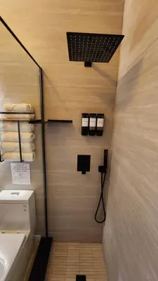 a bathroom with a toilet and a sink and towels at Pop Art Loft in Hialeah